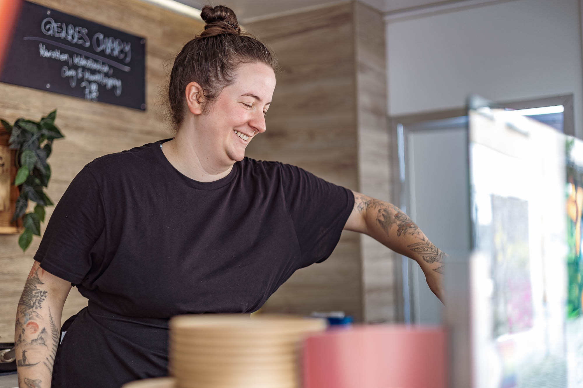 Authentische Businessfotografie im Foodtruck – JessyGraphy Berlin Anne lächelt beim Pasta-Kochen in ihrem Foodtruck – Businessfotografie ohne Posen